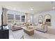 Bright living room with neutral furniture, modern decor, large windows and stylish mirrors at 10148 Hadley St, Orlando, FL 32829