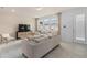 Comfortable living room featuring neutral furniture, entertainment center and large windows for abundant natural light at 10148 Hadley St, Orlando, FL 32829