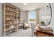 This home office features built-in bookshelves, lots of natural light, and modern finishes at 10148 Hadley St, Orlando, FL 32829