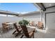 An outdoor patio with brick pavers, several Adirondack chairs, a small table and a plant arrangement at 10148 Hadley St, Orlando, FL 32829