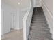 Bright interior showcasing a carpeted staircase with white risers and a hallway leading to other rooms at 10148 Hadley St, Orlando, FL 32829