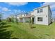 Expansive backyard with well-manicured lawn, patio, and newly planted trees at 10245 Park Estates Ave, Orlando, FL 32836