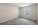Bedroom featuring light walls and soft gray carpet complemented by a window at 10245 Park Estates Ave, Orlando, FL 32836
