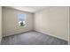 Cozy bedroom with soft carpet, light walls, and natural light streaming in from a window at 10245 Park Estates Ave, Orlando, FL 32836