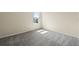 Bright bedroom features neutral walls and plush gray carpeting creating a cozy atmosphere at 10245 Park Estates Ave, Orlando, FL 32836