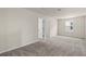 Spacious bedroom featuring carpet floors, light-colored walls, and natural light from the window at 10245 Park Estates Ave, Orlando, FL 32836