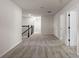 Upstairs hallway with cozy carpet and a staircase that features black iron spindles at 10245 Park Estates Ave, Orlando, FL 32836