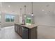 Bright, spacious kitchen with a large island and stylish pendant lighting overlooking the backyard at 10245 Park Estates Ave, Orlando, FL 32836