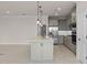 Charming kitchen features an island with pendant lights and modern stainless steel appliances at 10245 Park Estates Ave, Orlando, FL 32836