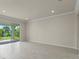 Open-concept living room with sliding glass doors that provide views of the backyard at 10245 Park Estates Ave, Orlando, FL 32836