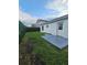 Backyard with grass area, privacy green fence, and access door to the home at 1025 Clovercrest Rd, Orlando, FL 32811