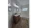 Modern bathroom features a patterned vanity, framed mirror, and tiled floors at 1025 Clovercrest Rd, Orlando, FL 32811