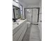 Contemporary bathroom with dual lighting, dark framed mirror, and glass shower at 1025 Clovercrest Rd, Orlando, FL 32811