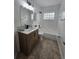 Modern bathroom features a patterned vanity, framed mirror, and tiled floors at 1025 Clovercrest Rd, Orlando, FL 32811
