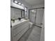 Contemporary bathroom with dual lighting, dark framed mirror, and glass shower at 1025 Clovercrest Rd, Orlando, FL 32811
