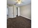 Neutral bedroom features a ceiling fan, carpeted floors, and an open closet at 1025 Clovercrest Rd, Orlando, FL 32811