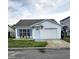 Charming single-story home featuring white stucco exterior, blue shutters, and a well-maintained lawn at 1025 Clovercrest Rd, Orlando, FL 32811
