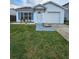 Charming single-story home featuring a well-manicured lawn, blue shutters and a one car garage at 1025 Clovercrest Rd, Orlando, FL 32811