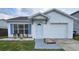 Charming home with blue shutters, a well-maintained lawn, and a one-car garage at 1025 Clovercrest Rd, Orlando, FL 32811