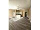 Open-concept living space with modern wood-look flooring, connecting the living and kitchen areas at 1025 Clovercrest Rd, Orlando, FL 32811