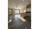 Open layout showcasing the living room, kitchen with granite counter, and modern flooring at 1025 Clovercrest Rd, Orlando, FL 32811