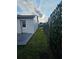 Side yard featuring a new privacy fence and grass area leading to the front at 1025 Clovercrest Rd, Orlando, FL 32811