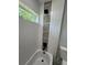 Bathroom featuring white tiling, horizontal window, mosaic tiling accent, and tub with black fixtures at 10641 Sw 110Th Ct, Dunnellon, FL 34432