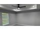 The bedroom features a modern ceiling fan and window with horizontal blinds at 10641 Sw 110Th Ct, Dunnellon, FL 34432