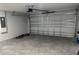 Spacious two-car garage provides ample room for parking and storage, with a concrete floor at 10641 Sw 110Th Ct, Dunnellon, FL 34432