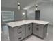 The kitchen island features gray cabinets with sleek black hardware, offering modern storage and a clean design at 10641 Sw 110Th Ct, Dunnellon, FL 34432