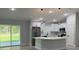 Bright kitchen featuring white cabinets, stainless steel appliances, and a modern island at 10641 Sw 110Th Ct, Dunnellon, FL 34432