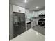 Spacious kitchen featuring stainless steel appliances and white cabinets and quartz countertops at 10641 Sw 110Th Ct, Dunnellon, FL 34432