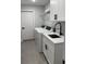 Laundry room featuring white cabinets, sink, washer, and dryer at 10641 Sw 110Th Ct, Dunnellon, FL 34432