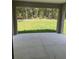 Covered patio offers a serene outdoor space with views of the lush green backyard at 10641 Sw 110Th Ct, Dunnellon, FL 34432