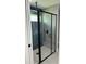 A modern glass shower features a black frame and fixtures with vertical accent tile at 10641 Sw 110Th Ct, Dunnellon, FL 34432