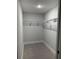 Efficient walk-in closet with white trim and wire shelving for optimal storage solutions in a modern aesthetic at 10641 Sw 110Th Ct, Dunnellon, FL 34432