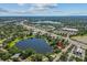 Panoramic aerial view of lakes surrounded by verdant landscapes, residential areas, and bustling streets at 11 Plumosa Ave, Casselberry, FL 32707