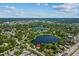 Expansive aerial perspective of two lakes surrounded by lush greenery, residential neighborhoods, and a busy thoroughfare at 11 Plumosa Ave, Casselberry, FL 32707