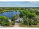 Aerial view of property featuring large lake, beautiful landscaping, and scenic views, ideal for relaxation and outdoor activities at 11 Plumosa Ave, Casselberry, FL 32707