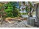 Relax on this brick patio surrounded by mature trees and serene lake views at 11 Plumosa Ave, Casselberry, FL 32707
