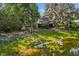 Large backyard overlooking calm lake, featuring trees, and lush lawn; perfect for relaxation and enjoying nature at 11 Plumosa Ave, Casselberry, FL 32707