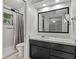 Clean, updated bathroom with a shower, vanity, and large mirror, offering a comfortable and functional space at 11 Plumosa Ave, Casselberry, FL 32707