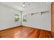 Bright bedroom with hardwood floors, two windows, and a ceiling fan at 11 Plumosa Ave, Casselberry, FL 32707