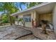A cozy home exterior with a well-maintained yard, tropical plants, and a glimpse of the nearby lake at 11 Plumosa Ave, Casselberry, FL 32707