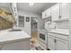 Cozy kitchen with white cabinetry, window, and tiled backsplash at 11 Plumosa Ave, Casselberry, FL 32707