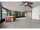 Relaxing enclosed sunroom with hot tub and tranquil water views, perfect for year-round enjoyment at 11 Plumosa Ave, Casselberry, FL 32707