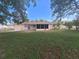 View of the backyard with a screened-in lanai and a fenced-in yard at 11282 Sw 62Nd Avenue Rd, Ocala, FL 34476