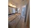 Primary bathroom features a long vanity countertop and a large framed mirror at 11282 Sw 62Nd Avenue Rd, Ocala, FL 34476