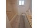 Neutral-colored bathroom features a tub, granite countertop and ceramic tile flooring at 11282 Sw 62Nd Avenue Rd, Ocala, FL 34476