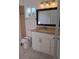 Updated bathroom featuring a granite countertop, a framed mirror, and white vanity at 11282 Sw 62Nd Avenue Rd, Ocala, FL 34476